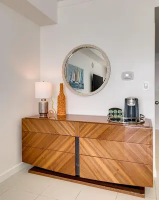 a mirror on top of a dresser in a room at Ocean View Balcony steps from Restaurants, Peacock Park & Marina in Miami