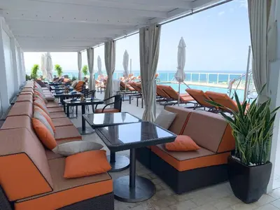 a restaurant with couches and tables and a view of the ocean at Ocean View Balcony steps from Restaurants, Peacock Park & Marina in Miami