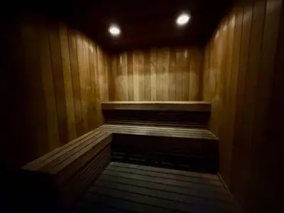 a empty wooden sauna with a wooden floor and lights at City View Balcony steps from Restaurants, Peacock Park & Marina in Miami