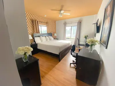 a bedroom with a bed and a desk with flowers on it at Notebook Miami Beach in Miami Beach