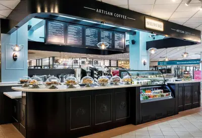 a bakery with a counter with pastries on it at DoubleTree by Hilton Hotel Miami Airport & Convention Center in Miami