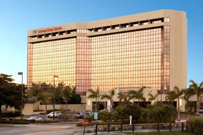 a large building with a sign on top of it at DoubleTree by Hilton Hotel Miami Airport & Convention Center in Miami