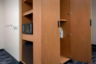 a cupboard with a microwave and a door to a room at Fairfield Inn & Suites by Marriott Miami Airport West/Doral in Miami