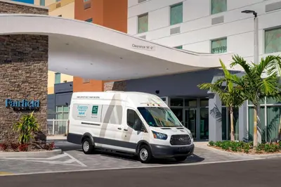 a white van parked in front of a building at Fairfield Inn & Suites by Marriott Miami Airport West/Doral in Miami