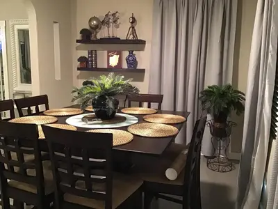a dining room with a table with chairs and a tableablish at Modern 3/1 house close to Beaches and Midtown in Miami