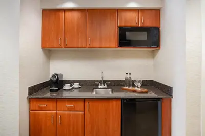 a kitchen with a sink and a microwave at Trump International Beach Resort - Sunny Isles Beach in Miami Beach