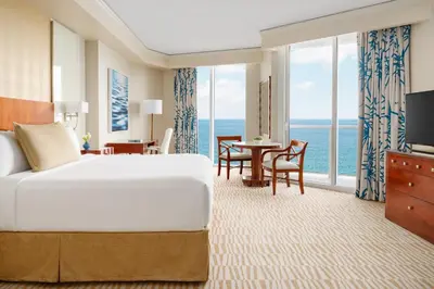 a hotel room with a bed and a view of the ocean at Trump International Beach Resort - Sunny Isles Beach in Miami Beach