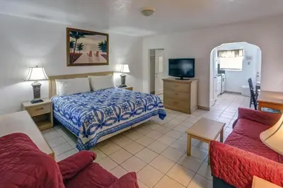 a hotel room with a bed and a tv at Richard's Motel Extended Stay in Hallandale Beach