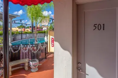 a door to a resort with a swimming pool at Richard's Hotel in Hollywood