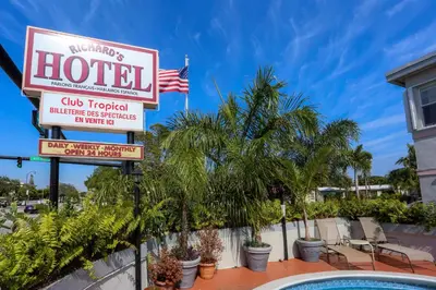a sign for a hotel with palm trees at Richard's Hotel in Hollywood