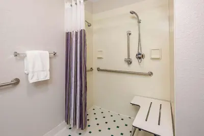 a bathroom with a shower with a toilet and a sink at La Quinta by Wyndham Ft. Lauderdale Plantation in Plantation