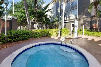 a swimming pool in front of a building at La Quinta by Wyndham Ft. Lauderdale Plantation in Plantation