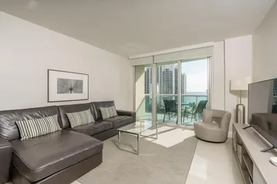 a living room with a couch and a glass table at Ocean Reserve 14th floor - Wonderful Ocean View - STR00454 in Miami Beach