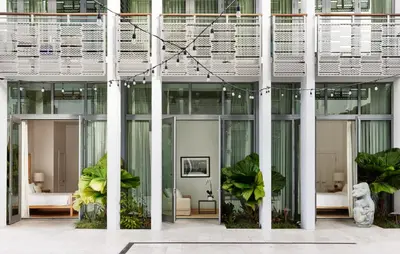 an office building with glass doors and plants at The Betsy Hotel, South Beach in Miami Beach