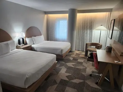 a hotel room with two beds and a desk at Miami International Airport Hotel in Miami