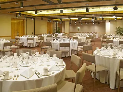 a banquet hall with tables and chairs with white tablecloths at Miami International Airport Hotel in Miami