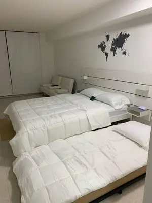 a bedroom with two beds and a world map on the wall at Centric Modern, Stylish Brickell / Miami + FREE Parking in Miami