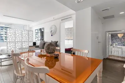 a dining room and living room with a table and chairs at 1100 West South Beach Luxe Miami Condos by Joe Semary in Miami Beach