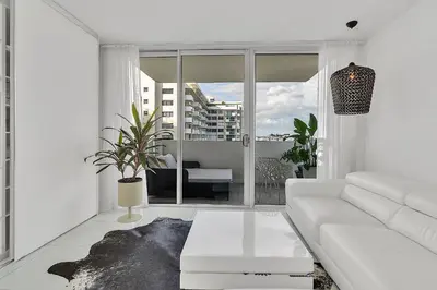 a white living room with a white couch at 1100 West South Beach Luxe Miami Condos by Joe Semary in Miami Beach