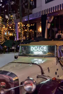 an old car with a sign on the front at Gale South Beach, Curio Collection By Hilton in Miami Beach