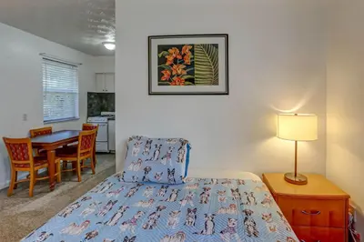 a bedroom with a bed and a table with a lamp at Richard's Pet Friendly Motel in Hollywood