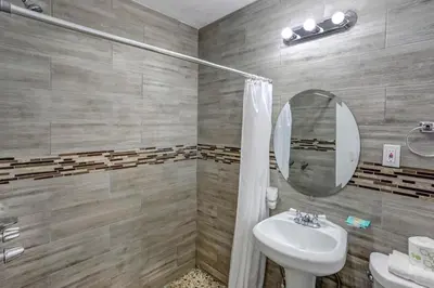 a bathroom with a sink and a mirror at Richard's Motel Courtyard in Hollywood