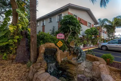 a fake waterfall in front of a house at Richard's Motel Studios in Hollywood