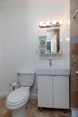 a bathroom with a toilet and a sink and a mirror at The Dolphin Hollywood in Hollywood