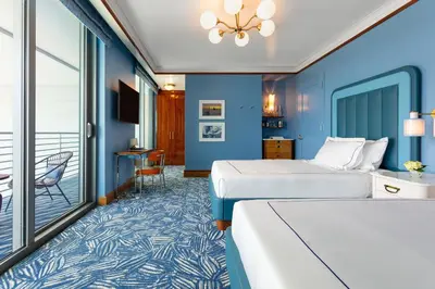 a hotel room with two beds and a balcony at Mr. C Miami - Coconut Grove in Miami