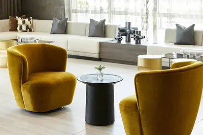 a living room with two chairs and a table at AC Hotel by Marriott Miami Airport West/Doral in Miami