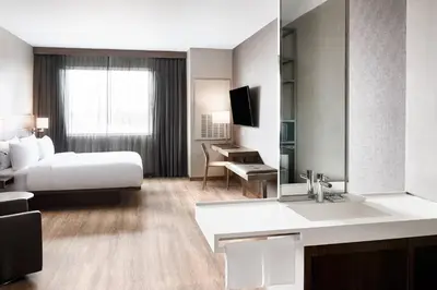 a hotel room with a bed and a bathroom at AC Hotel by Marriott Miami Airport West/Doral in Miami