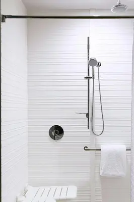 a white bathroom with a shower and a toilet at AC Hotel by Marriott Miami Airport West/Doral in Miami
