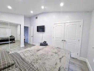 a bedroom with a large bed and a mirror at Downtown Hollywood - 3 miles to Beach - Sleeps 8 in Hollywood