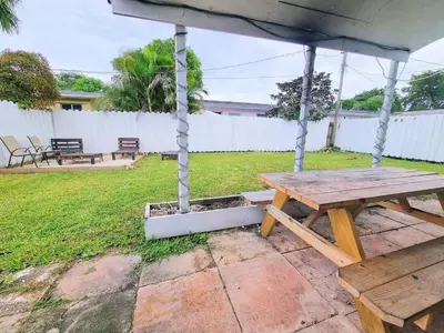 a picnic table under an umbrella in a yard at Downtown Hollywood - 3 miles to Beach - Sleeps 8 in Hollywood