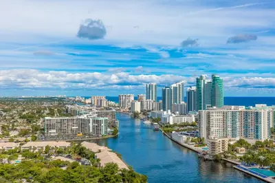 an aerial view of a city with a river at Private Ocean Luxury Condos at Beachwalk Resort in Hallandale Beach