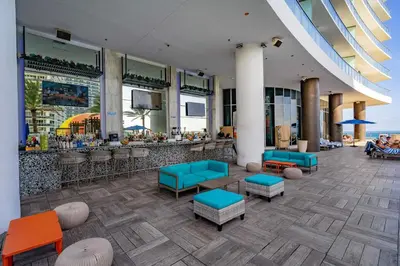 a lobby with a bar with blue and orange seats at Private Ocean Condos at Hyde Beach Resort & Residences in Hollywood