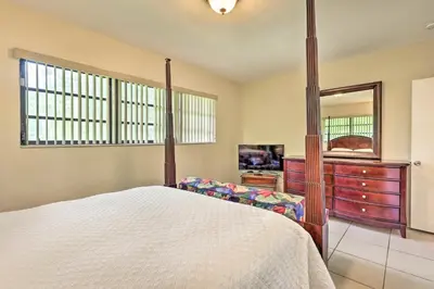 a bedroom with a bed and a dresser and a mirror at 7545 Southwest 124th Street in Miami