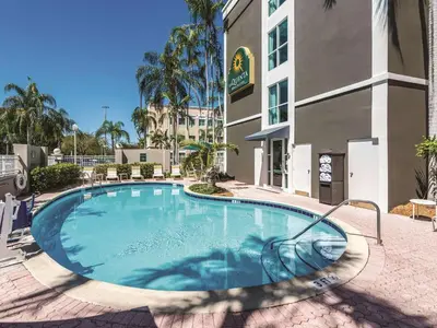 a large swimming pool in front of a building at La Quinta by Wyndham Plantation at SW 6th St in Plantation