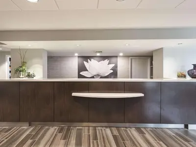 a lobby with a lotus flower on the wall at La Quinta by Wyndham Plantation at SW 6th St in Plantation
