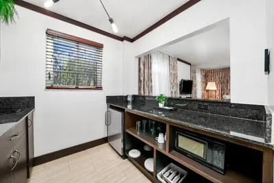 a bathroom with a sink and a mirror at Lincoln Arms Suites in Miami Beach