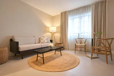 a living room with a couch and a table at Hotel Greystone - Adults Only in Miami Beach