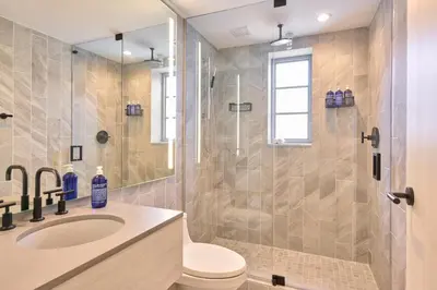 a bathroom with a shower and a toilet and a sink at Hotel Greystone - Adults Only in Miami Beach