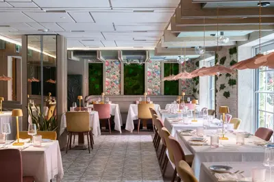 a dining room with white tables and chairs at Lennox Miami Beach in Miami Beach