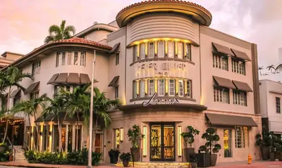 a large white building with trees in front of it at Lennox Miami Beach in Miami Beach