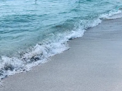 a wave breaking on the shore of a beach at Sunrise Penthouse ocean view terrace beach few steps away SOBE in Miami Beach