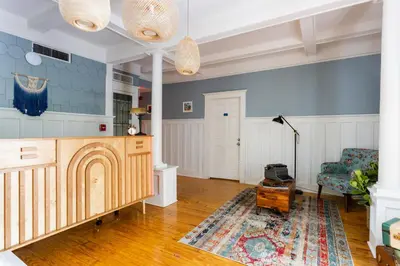 a living room with blue walls and a table at Miami River Inn by Renzzi in Miami