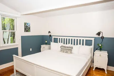 a bedroom with a white bed and blue walls at Miami River Inn by Renzzi in Miami