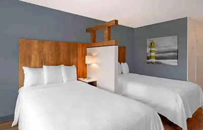 a bedroom with two beds and a lighthouse on the wall at Extended Stay America Premier Suites - Miami - Downtown Brickell - Cruise Port in Miami