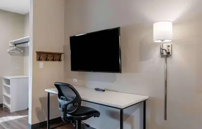 a room with a desk with a chair and a flat screen tv at Extended Stay America Premier Suites - Miami - Airport - Doral - 25th Street in Miami