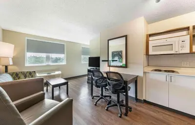a living room with a kitchen and a living room with a table at Extended Stay America Premier Suites - Miami - Airport - Doral - 25th Street in Miami